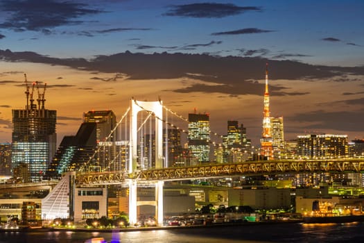 Aerial view of Tokyo skylines with Rainbow bridge and tokyo tower over Tokyo bay Sunset Twilight from Odaiba in Tokyo city Kanto Japan.