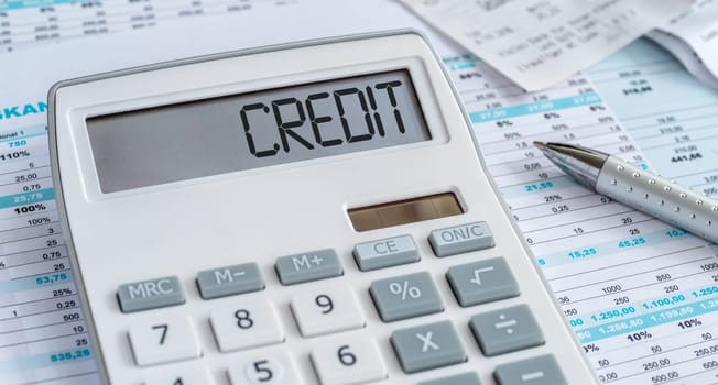 A calculator with the word Credit on the display