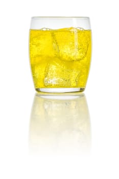 An orange soft drink with ice cubes