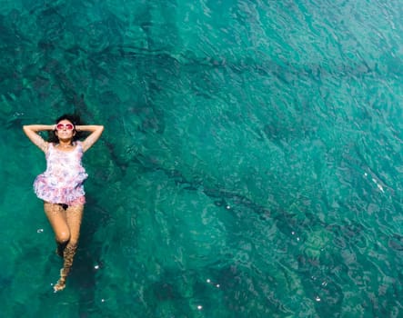 Aerial view of a beautiful woman dancing  in the sea