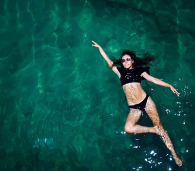 Aerial view of a woman relaxing in the sea