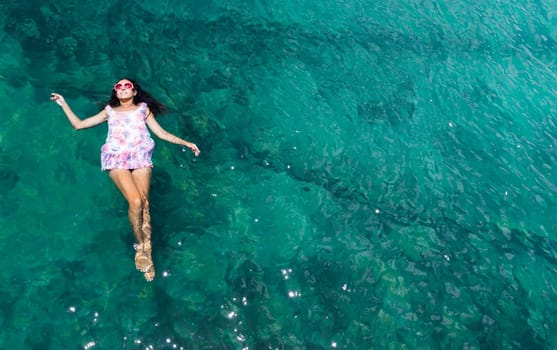 Aerial view of a beautiful woman dancing  in the sea