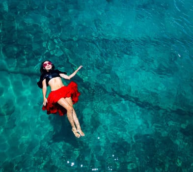 Aerial view of a beautiful woman dancing  in the sea