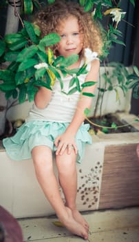 Portrait of a cute girl sitting ouddoor