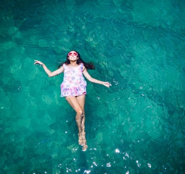 Aerial view of a beautiful woman dancing  in the sea