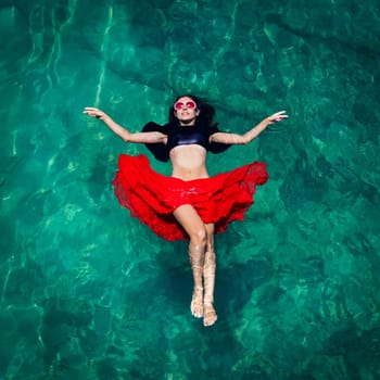 Aerial view of a beautiful woman dancing  in the sea