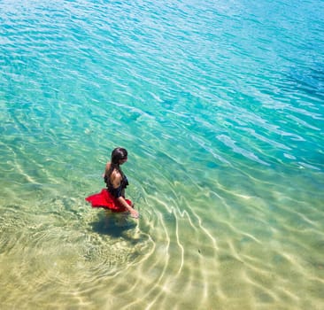 Aerial view of a beautiful woman dancing  in the sea