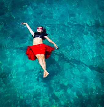 Aerial view of a beautiful woman dancing  in the sea
