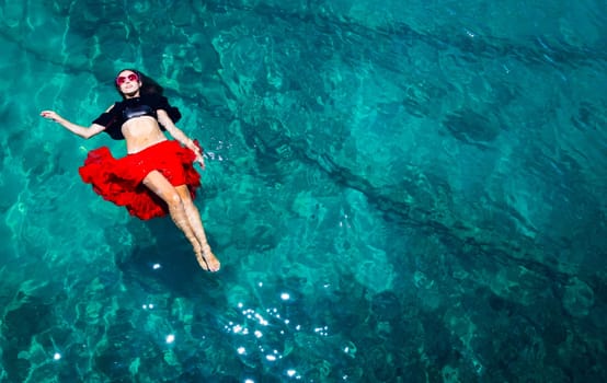 Aerial view of a beautiful woman dancing  in the sea