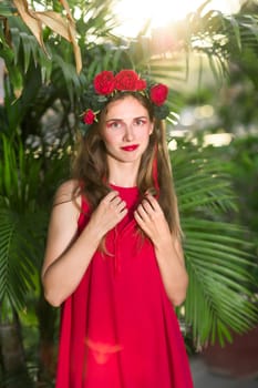 Fashion portrait of a beautiful woman in red dress outdoor