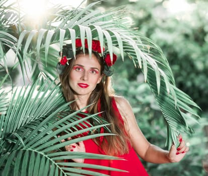 Fashion portrait of a beautiful woman in red dress outdoor