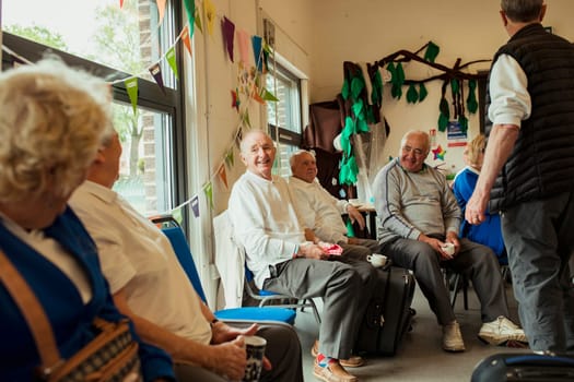 A group of senior adults sitting indoors and bonding with each other.