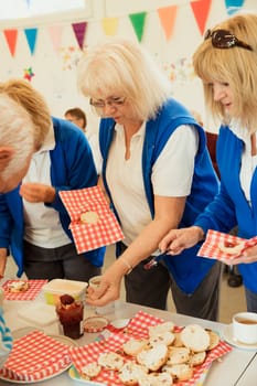 Senior friends taking a break and having some jam scones.