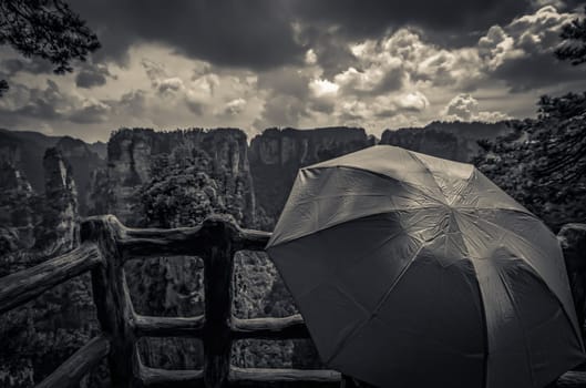 Tourists holding umbrella admiring the view and  on the scenic viewpoint, Avatar mountains nature park, Zhangjiajie, China