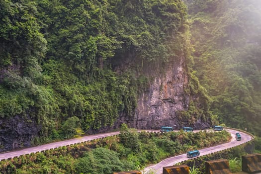 Buses with tourists driving up the winding road of 99 turns to the top of the Tianmen Mountain, Zhangjiajie National Park, Hunan, China