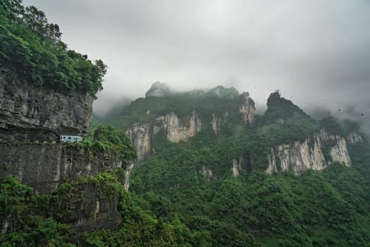 Bus with tourists driving up the winding road of 99 turns to the top of the Tianmen Mountain, Zhangjiajie National Park, Hunan, China