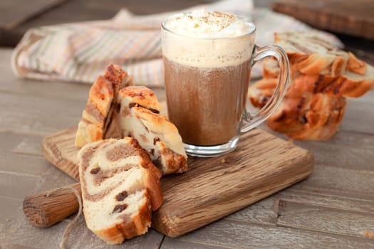 Mug of hot chocolate / coffee and slices of hazelnut cake