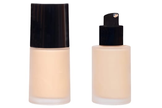 Cosmetic foundation isolated. Close-up of an closed and open glass bottle with liquid skin foundation isolated on a white background. Makeup concept of moisturiser and toner creme. Macro.