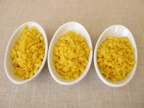 Pure beeswax pastilles for natural cosmetics, candles or beeswraps