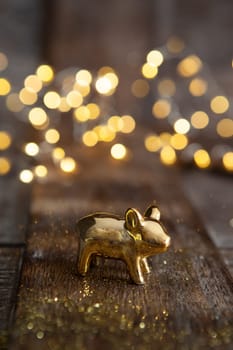 Golden lucky pig in front of bokeh lights