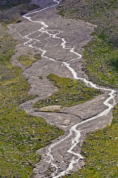 View to the Ödenwinkelkees with glacier stream in the Hohe Tauern
