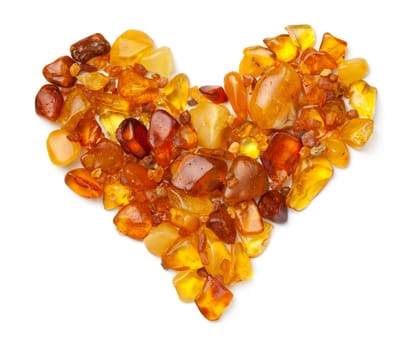 Heart made of ambers isolated on white background. Polished ambers. Top view, flat lay