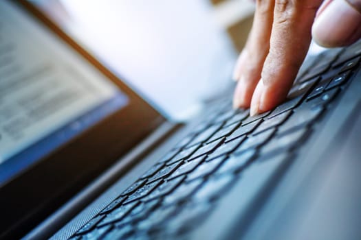 Networking and connecting concept, Hand human with keyboard on notebook computer blurred background