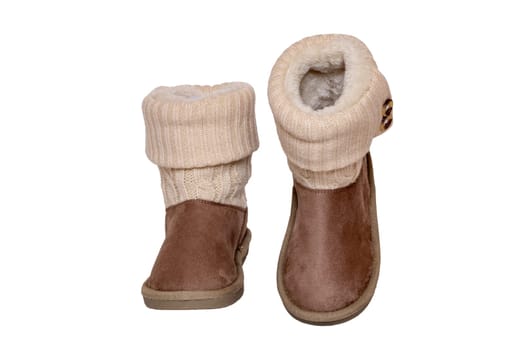 Winter boots. Close-up of a pair elegant brown suede leather winter boots with wool and lined with fur. Girls winter shoe fashion new collection. Isolated on a white background. Macro.