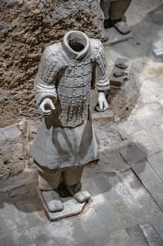 Xian, China -  July 2019 :  Standing clay soldierarmour forming part of an army of terracota warriors, created during the reign of first chinese emperor Qin Shi Huang Di, Shaanxi Province