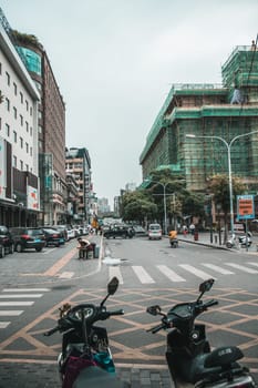 Xian, China -  July 2019 : Scooters parked on a street in the city of Xian in summer, Shaanxi Province