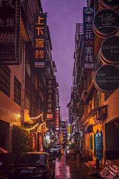 Zhangjiajie, China -  August 2019 : Narrow street in Zhangjiajie city during rainy night, Hunan Province