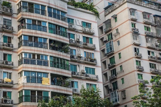 Chengdu, China -  July 2019 : Windows and balconies in high residential buildings and blocks of flats