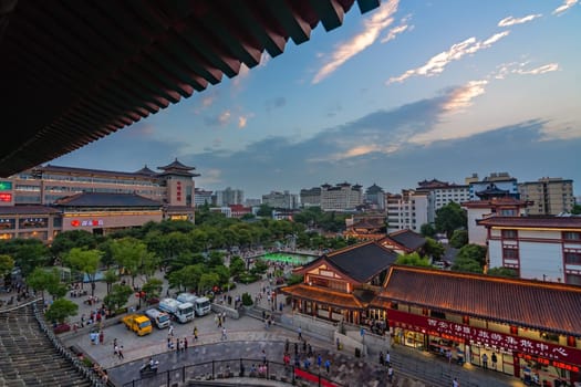 Xian, China -  July 2019 : Crowds walking among shops in the bustling streets of the Muslim Quarter in the evening as seen from the viewpoint in rum Tower, Shaaxi Province