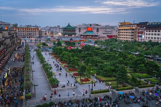 Xian, China -  July 2019 : Crowds walking on streets and town square with landmark Drum Tower in the background, Shaaxi Province