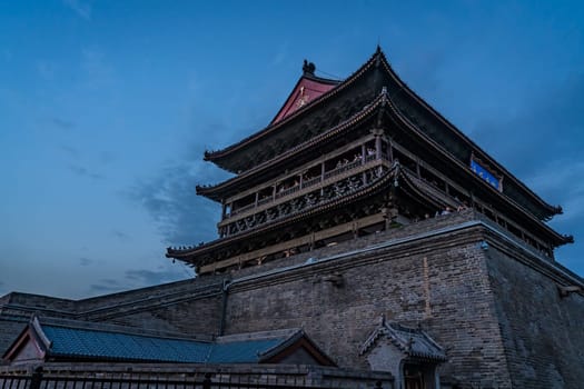 Xian, China -  July 2019 : Landmark Xian Bell Drum Tower photographed at dusk, Shaaxi Province