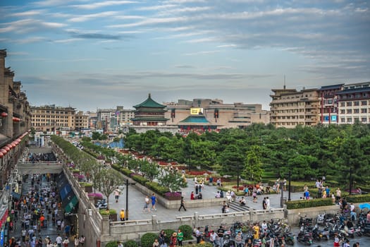 Xian, China -  July 2019 : Crowds walking on streets and town square with landmark Drum Tower in the background, Shaaxi Province