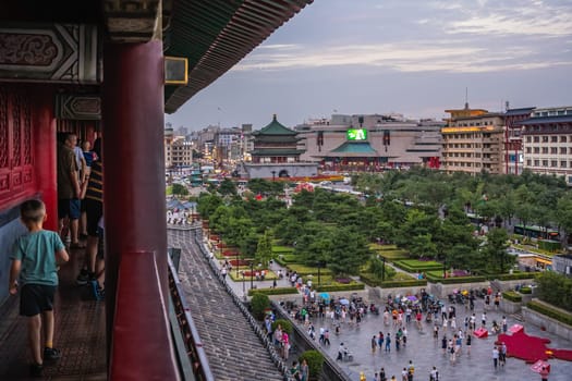 Xian, China -  July 2019 : View of the Xian town square with landmark Bell Tower in the background as seen from the visiting terrace in the Drum Tower, Xian city, Shaaxi Province