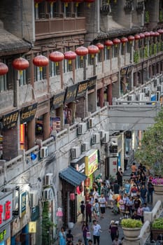 Xian, China -  July 2019 : Crowds walking on shopping street in Xian city, Shaaxi Province