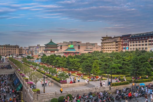 Xian, China -  July 2019 : Crowds walking on streets and town square with landmark Drum Tower in the background, Shaaxi Province