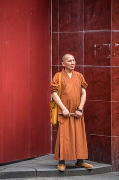 Chengdu, China -  July 2019 : Buddhist Monks standing on a pavement outside Wenshu Monastery in Chengdu town, Sichuan Province