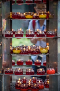 Chengdu, China -  July 2019 : Chinese man lightening up the memorial candle in the Wenshu Monastery