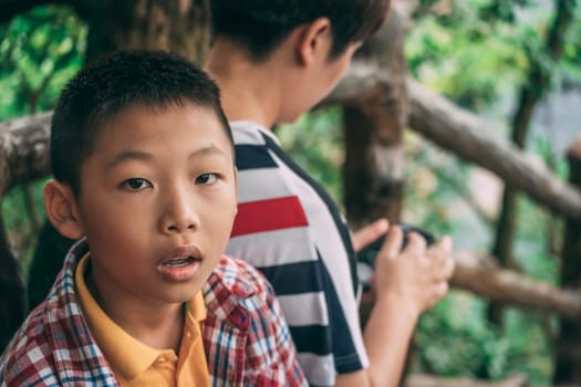 Zhangjiajie, China - August 2019 : Portrait of a young chinese boy on the viewpoint in Tianzi mountain range, Avatar mountains nature park