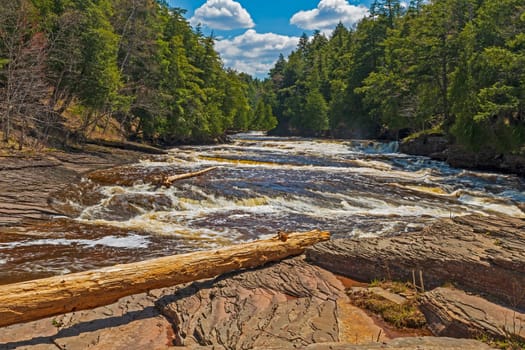 Raging River Flowing Past a Rocky Island on the Presque Isle River in Porcupine Mountains State Park in Michigan