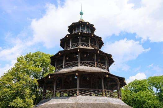 Restaurant and beer garden at wooden Chinese tower in English garden