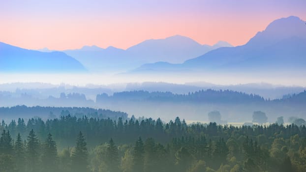 Aerial panoramic landscape of Upper Bavarian foggy foothills with morning sunrise over Alps mountains