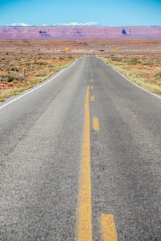 View of an endless straight road running through the desert in the USA