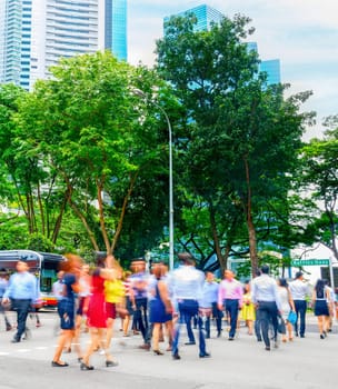 Cityscape with crowd of business people crossing road in Singapore downtown, metropolis skyline in background