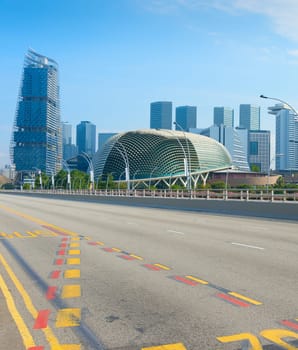 Empty road, modern skyscrapers and Esplanade Theatres on the Bay in Singapore