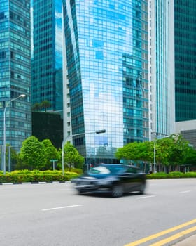 Rush hour in Singapore Downtown Core, car traffic on the road, modern architecture motion blur