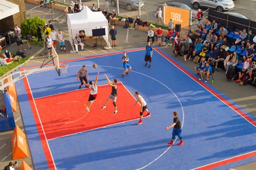KYIV, UKRAINE - SEPT 14, 2109: Men play basketball on a street. Street ball championship. Aerial view